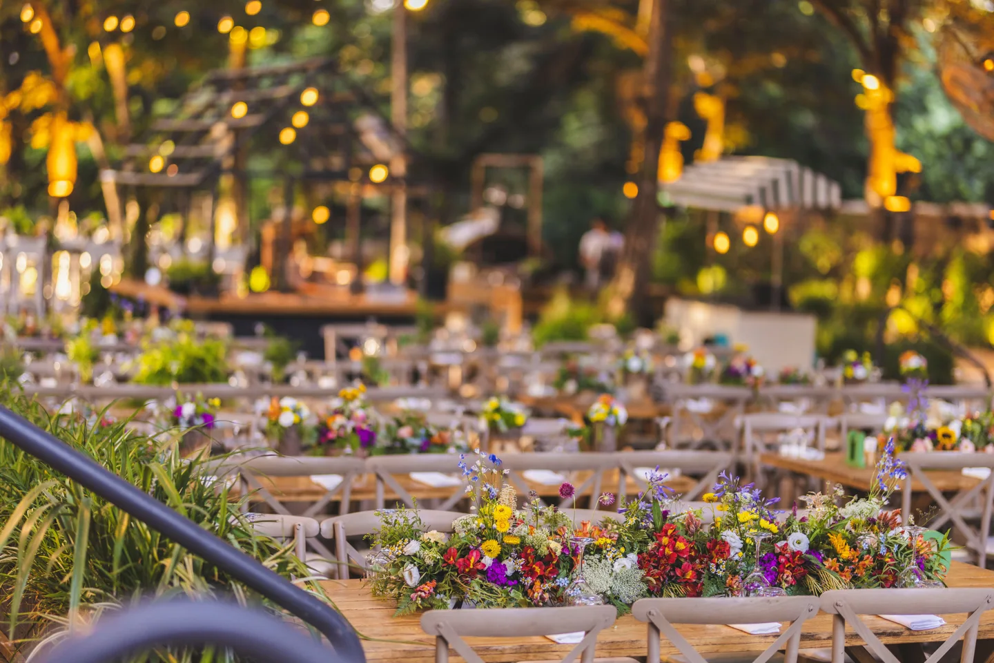 Colourful floral tables in an outdoor event setting